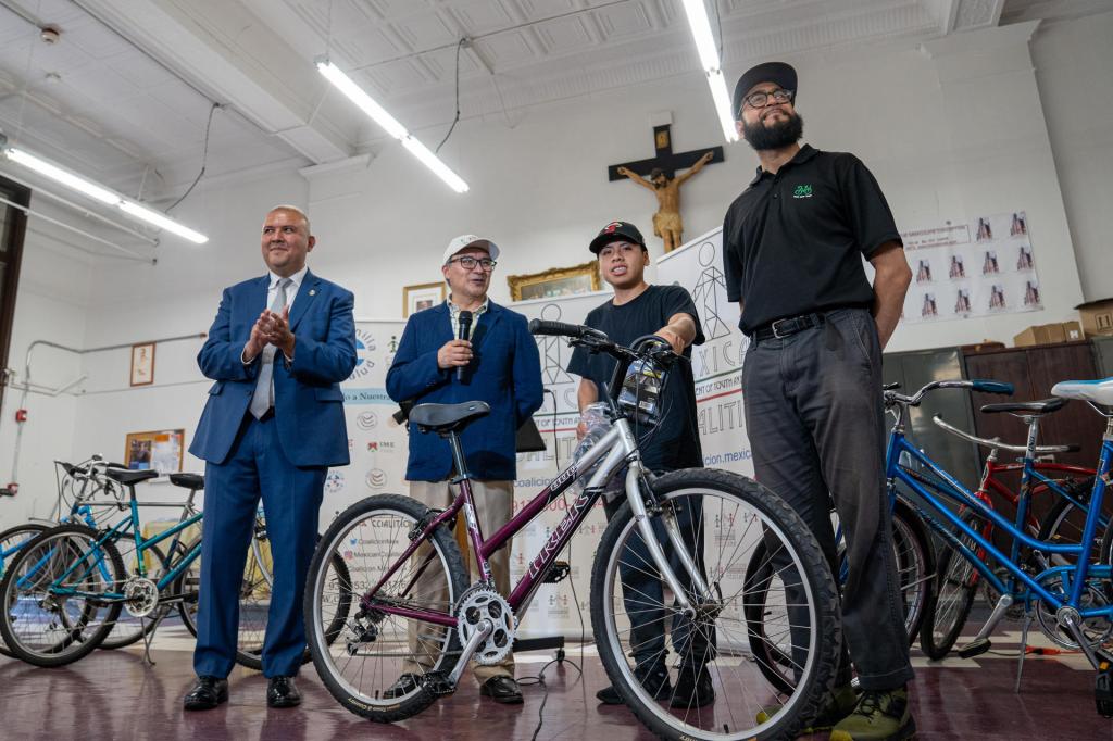 Manuel Castro (i), comisionado de Asuntos de los Inmigrantes, junto a representantes de las organizaciones Bike NY y Mexican Coalition, entregan bicicletas a inmigrantes, hoy, en New York (Estados Unidos)