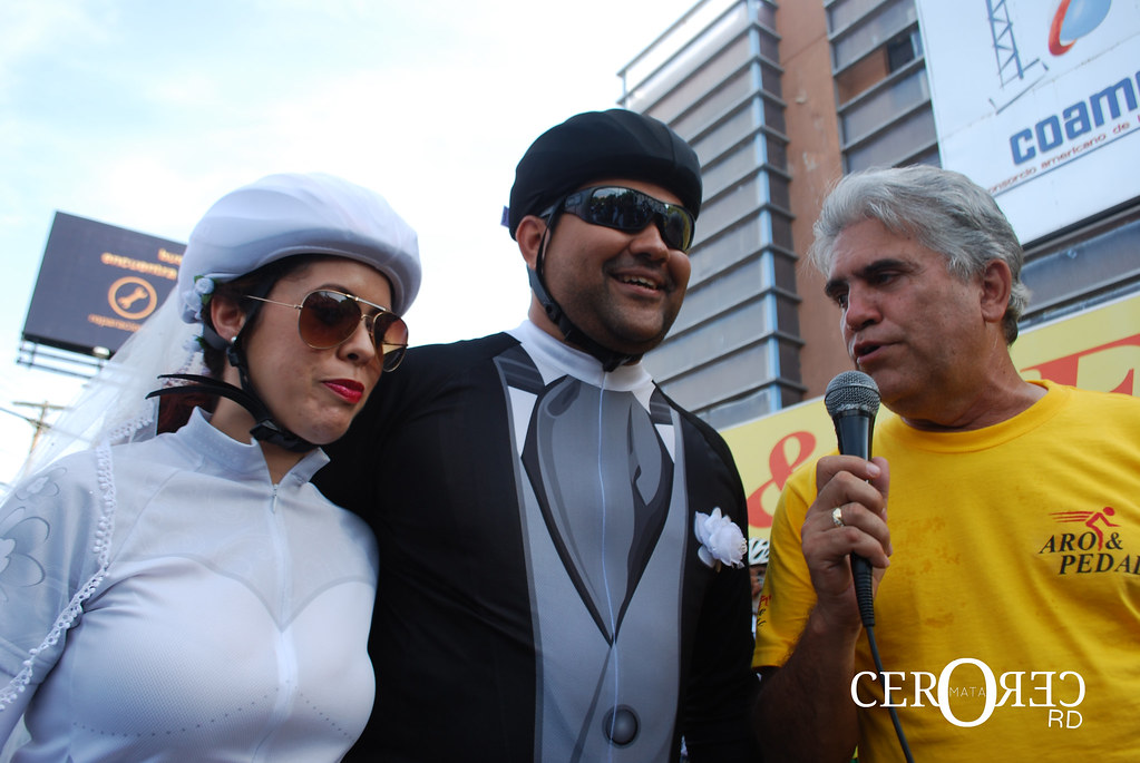 Entrevista de medios de comunicación a los novios durante la cicloboda en Santo Domingo junto al propietario de la tienda Aro & Pedal.